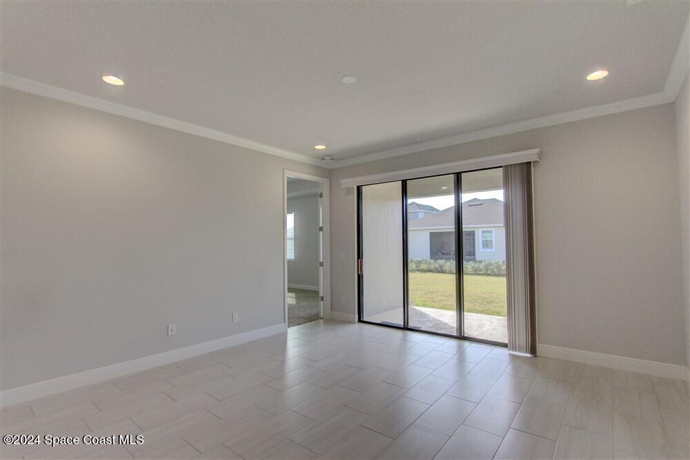 3267 Addison Drive Melbourne, FL 32940 - Photo 21 of 37 wooden floor in an empty room with a window