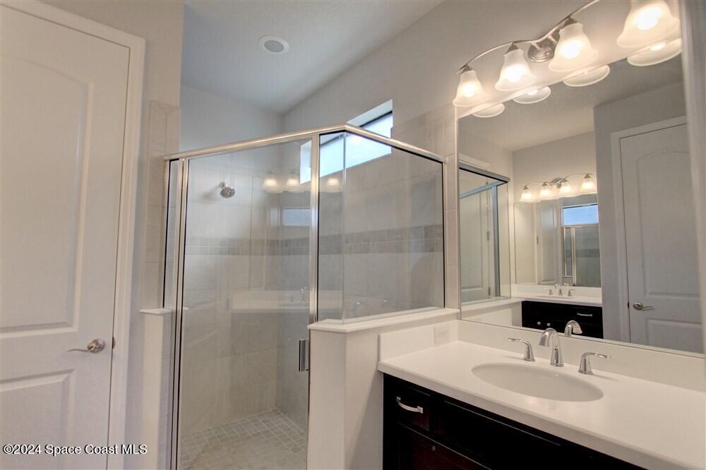 3267 Addison Drive Melbourne, FL 32940 - Photo 26 of 37 a bathroom with a sink shower and a mirror