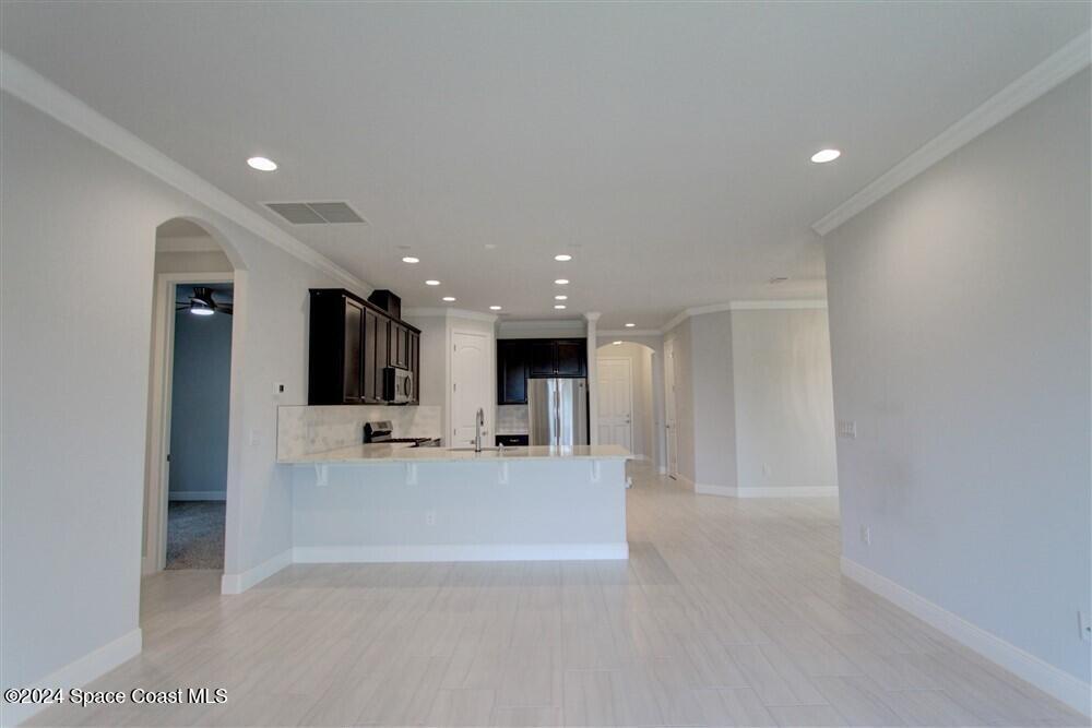 3267 Addison Drive Melbourne, FL 32940 - Photo 28 of 37 a view of a big room with kitchen view and a fireplace