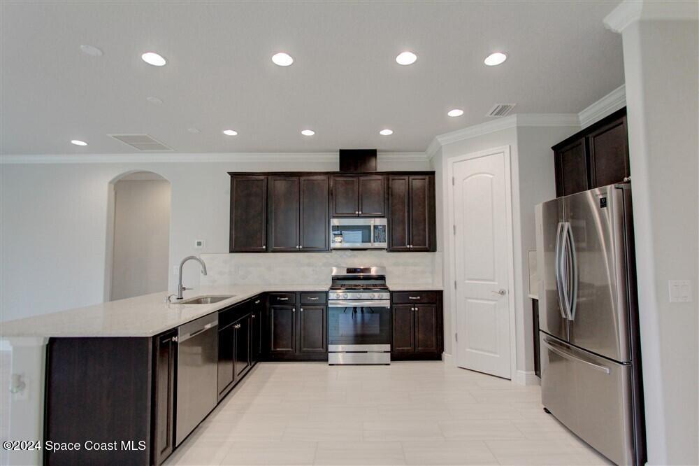 3267 Addison Drive Melbourne, FL 32940 - Photo 29 of 37 a kitchen with stainless steel appliances granite countertop a refrigerator and a sink