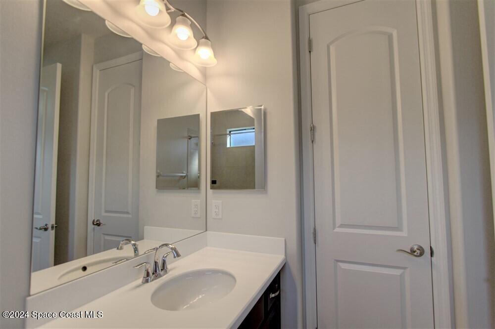 3267 Addison Drive Melbourne, FL 32940 - Photo 7 of 37 a bathroom with a sink and a mirror