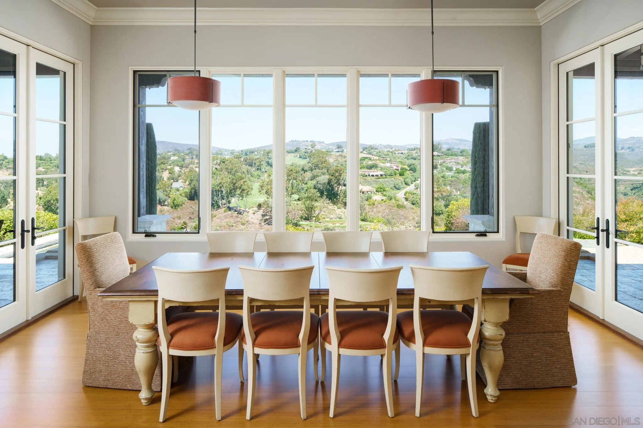 6248 Strada Fragante Rancho Santa Fe, CA 92091 - Photo 6 of 38 a dining room with wooden floor a chandelier a glass table and chairs