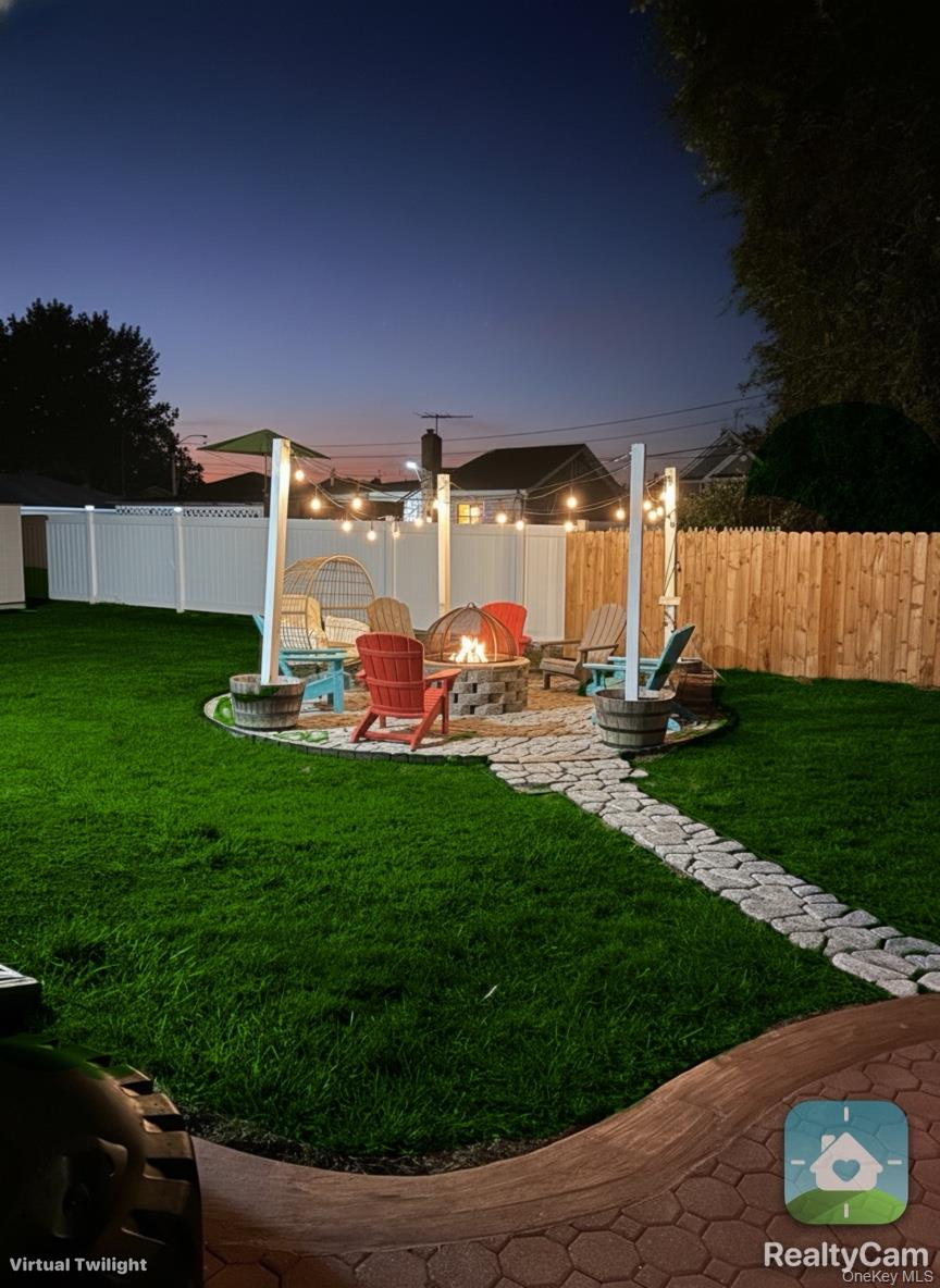 30 Classon Avenue Mastic, NY 11950 - Photo 21 of 21 Fenced backyard featuring a patio area and a fire pit