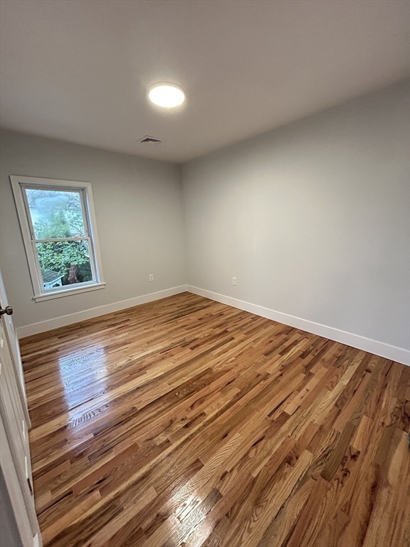 121 Horton Street, Unit 2 Fall River, MA 02723 - Photo 5 of 7 a view of empty room with wooden floor and fan