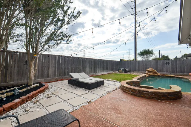 a backyard of a house with table and chairs