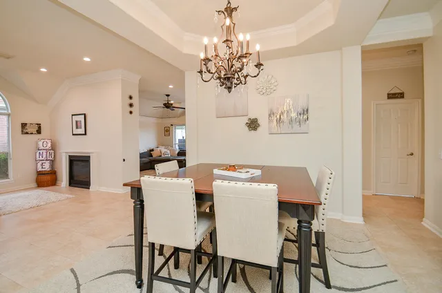 a view of a dining room with furniture and chandelier