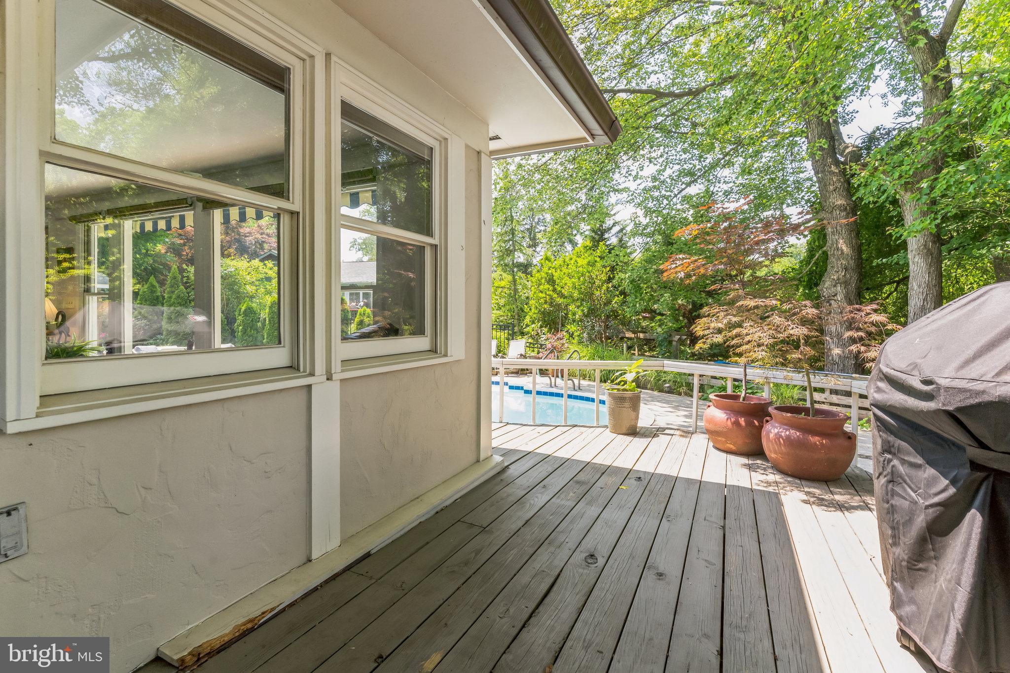 9329 Harvey Road Silver Spring, MD 20910 - Photo 30 of 40 a view of a chairs and table on the wooden deck