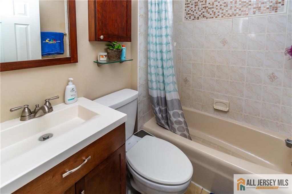 429 Edgeworth Street Middlesex, NJ 08846 - Photo 13 of 23 a bathroom with a sink a toilet and shower