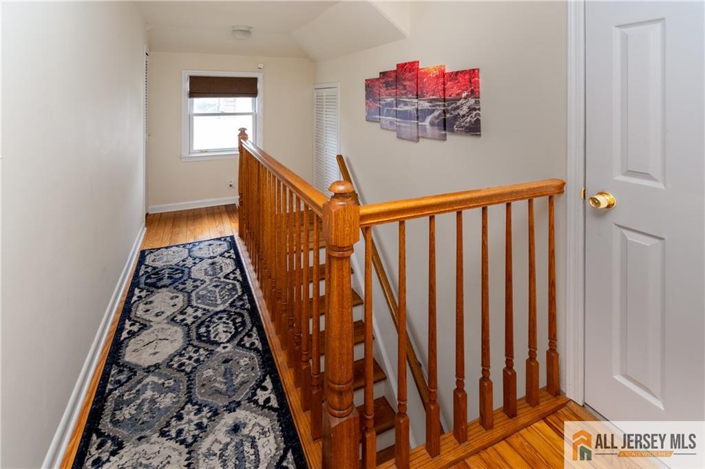 429 Edgeworth Street Middlesex, NJ 08846 - Photo 14 of 23 a view of a hallway with wooden floor and stairs