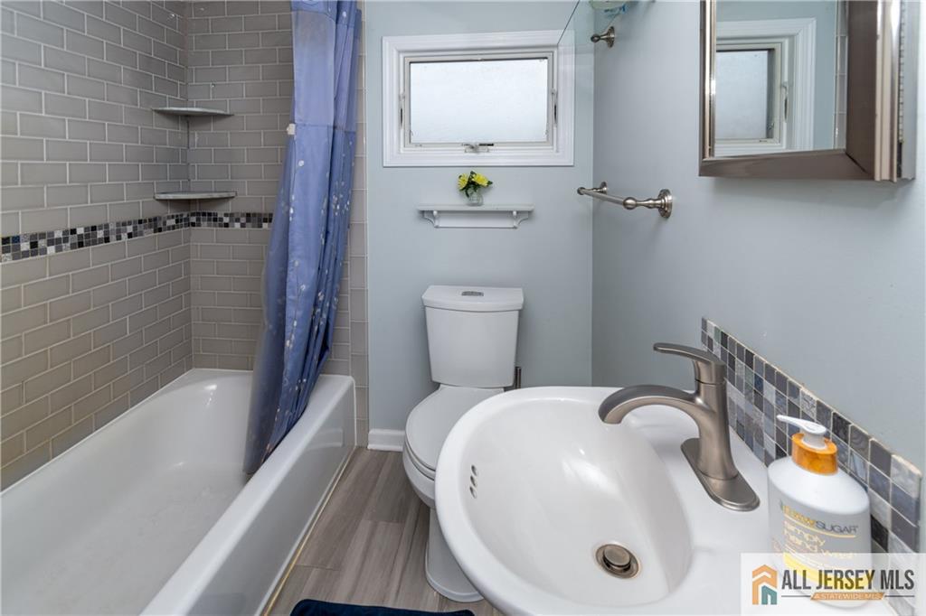 429 Edgeworth Street Middlesex, NJ 08846 - Photo 17 of 23 a bathroom with a sink a toilet and shower