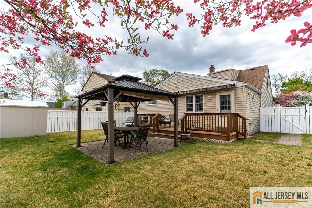 429 Edgeworth Street Middlesex, NJ 08846 - Photo 21 of 23 a patio with a table and chairs and a barbeque