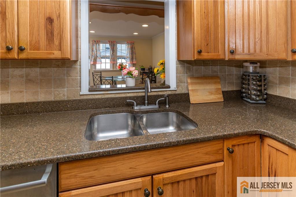 429 Edgeworth Street Middlesex, NJ 08846 - Photo 7 of 23 a kitchen with granite countertop a sink and cabinets