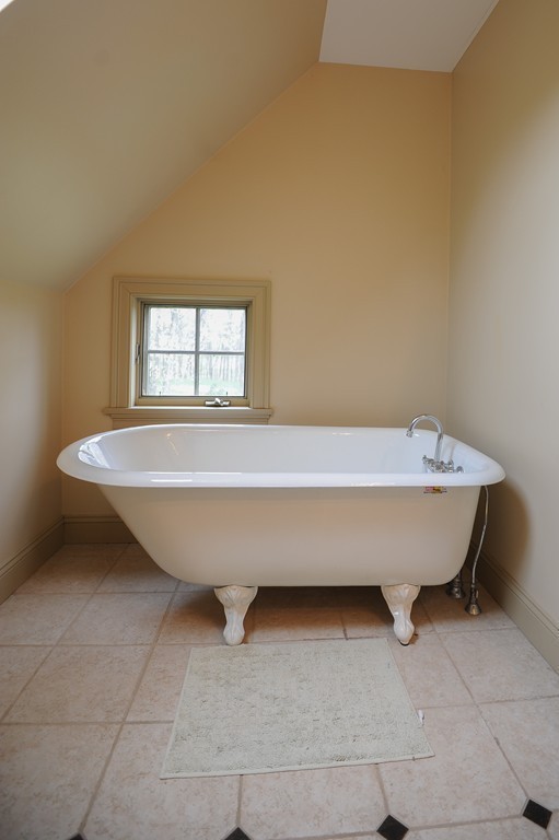 265 Leverett Road Amherst, MA 01002 - Photo 19 of 30 a bathroom with a bathtub and window