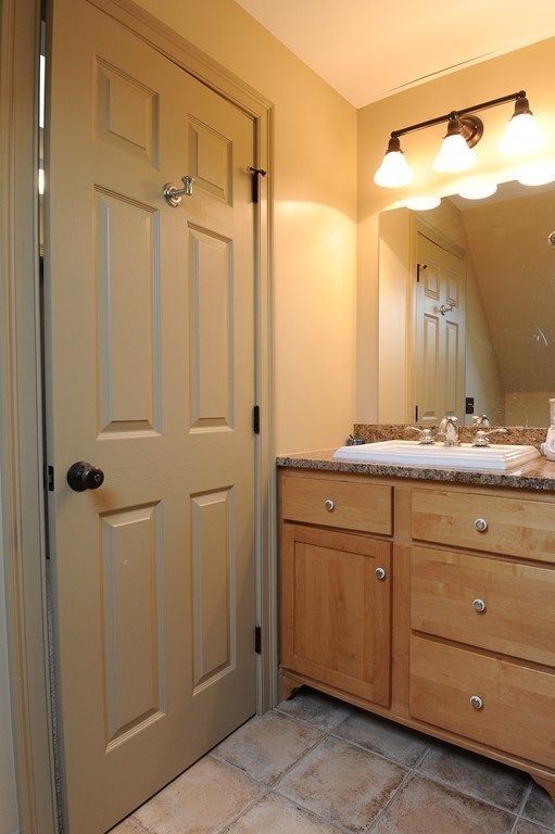 265 Leverett Road Amherst, MA 01002 - Photo 22 of 30 a bathroom with a granite countertop sink mirror and a shower