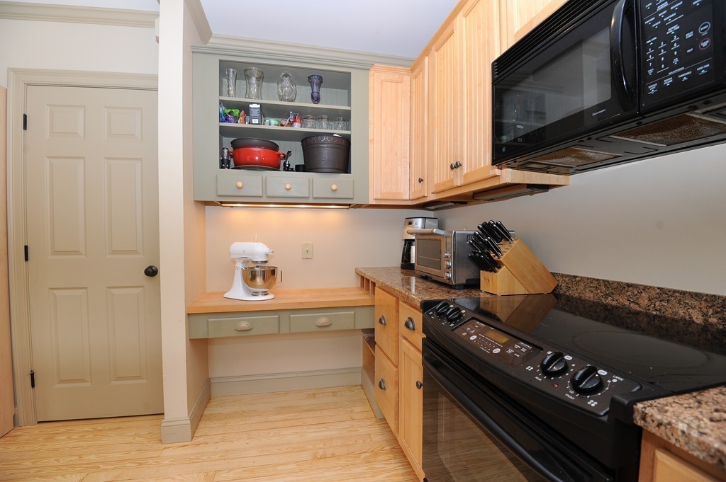265 Leverett Road Amherst, MA 01002 - Photo 5 of 30 a kitchen with stainless steel appliances granite countertop a stove and a microwave