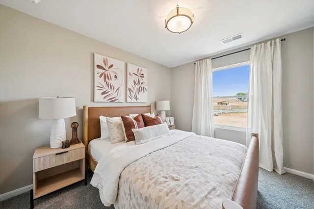 a bedroom with a bed and a lamp