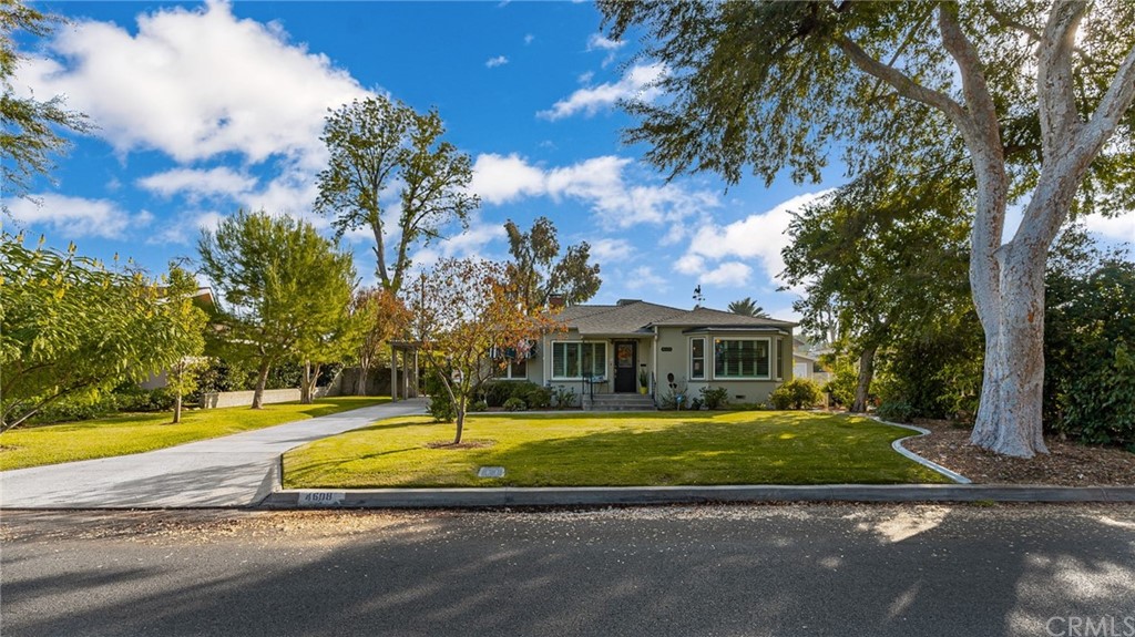 4608 Granada Avenue Riverside, CA 92504 - Photo 1 of 1 a view of a white house with a large pool and large trees