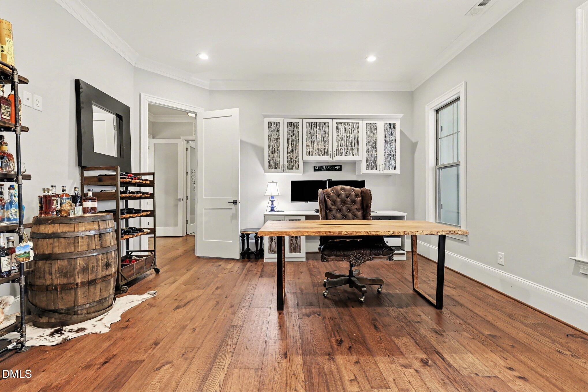 7433 Sextons Creek Drive Raleigh, NC 27614 - Photo 7 of 20 a view of a workspace with furniture and wooden floor