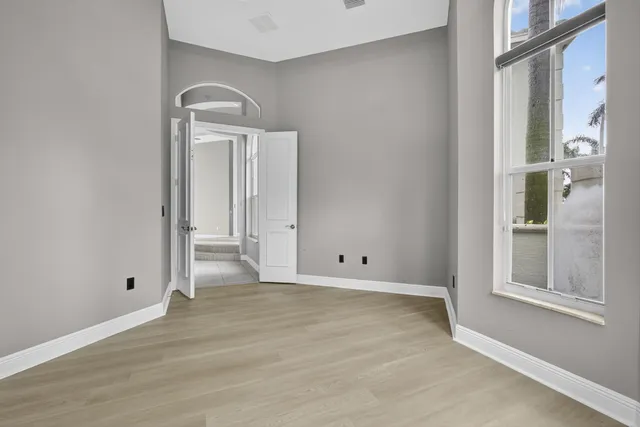 a bathroom with a granite countertop sink toilet mirror and shower