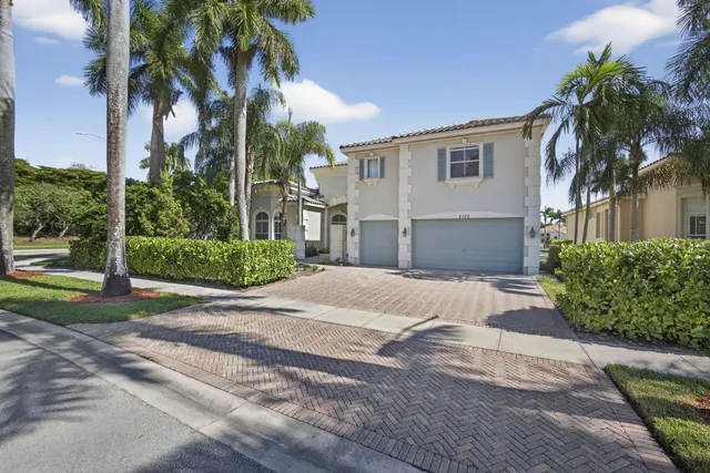 a front view of a house with a yard and a garage