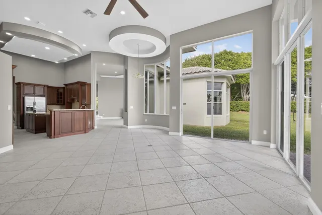 a view of a house with a yard and potted plants