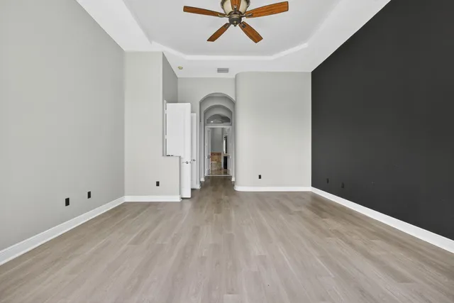 an aerial view of a house with a garden and lake view