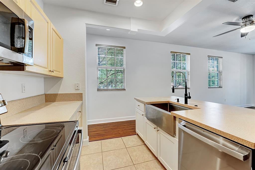 454 Southwest 147th Avenue, Unit 4601 Pembroke Pines, FL 33027 - Photo 17 of 45 a kitchen that has a sink and a stove