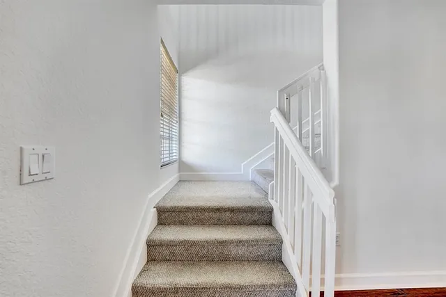 an empty room with a window and a ceiling fan