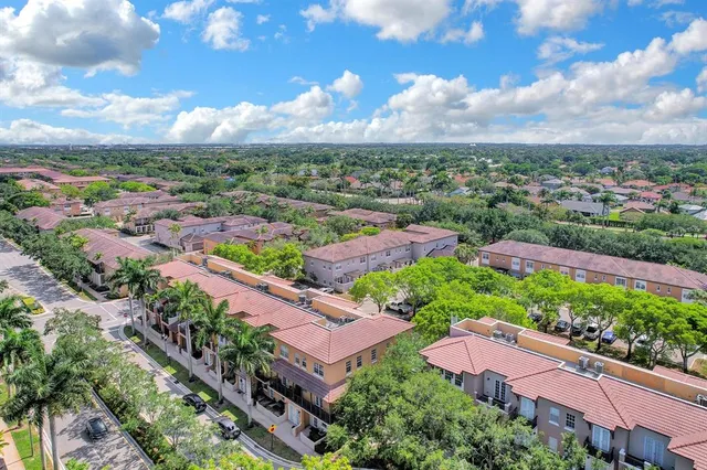 an aerial view of lake and residential houses with outdoor space