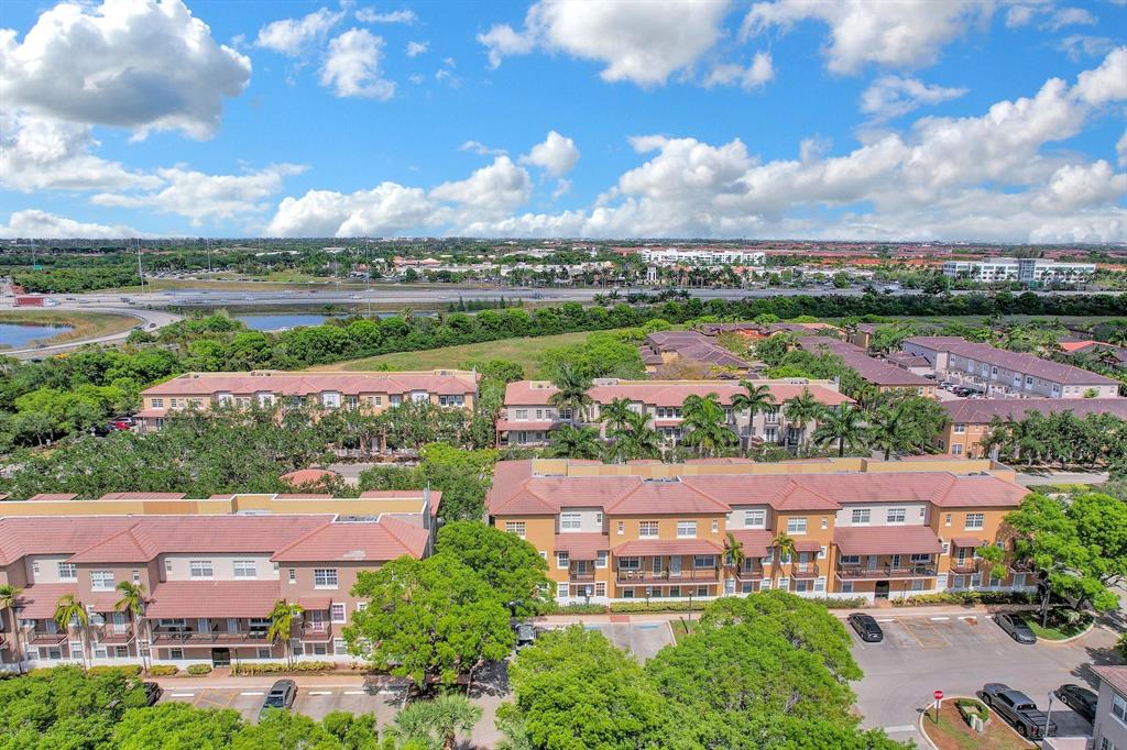 454 Southwest 147th Avenue, Unit 4601 Pembroke Pines, FL 33027 - Photo 43 of 45 an aerial view of a city with lots of residential buildings ocean and mountain view in back