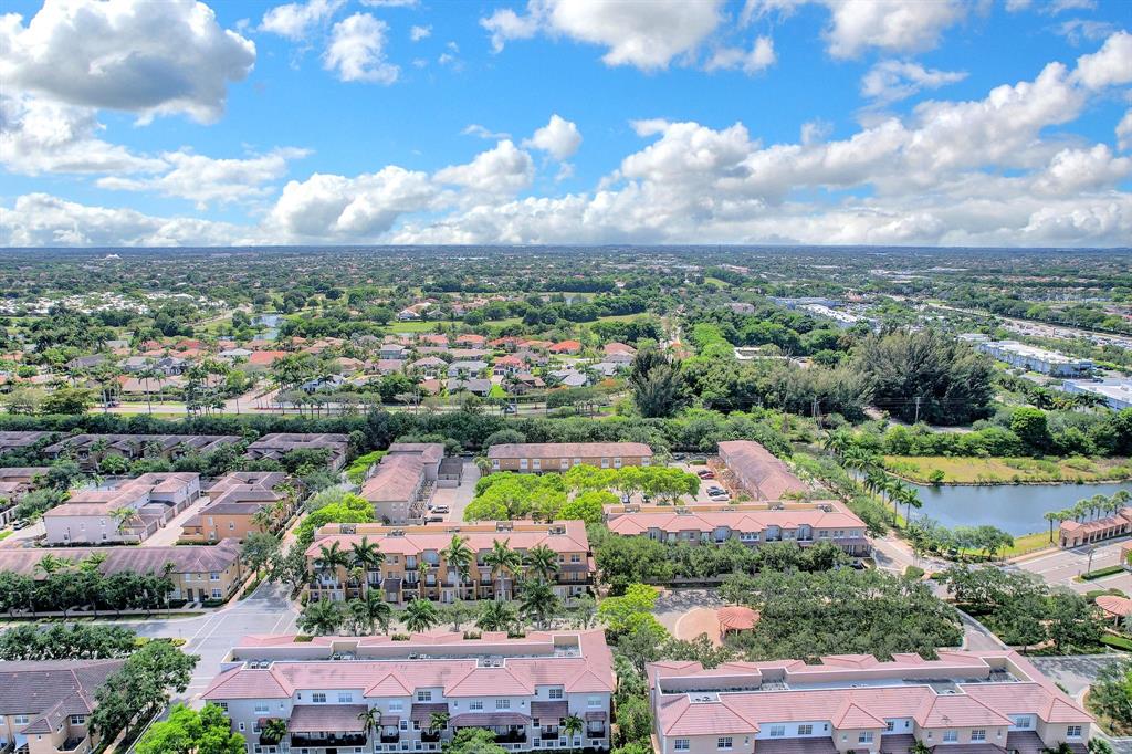454 Southwest 147th Avenue, Unit 4601 Pembroke Pines, FL 33027 - Photo 44 of 45 an aerial view of lake and residential houses with outdoor space