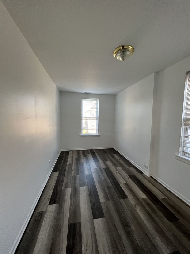 4533 South Richmond Street, Unit 2 Chicago, IL 60632 - Photo 4 of 7 wooden floor in an empty room with a window