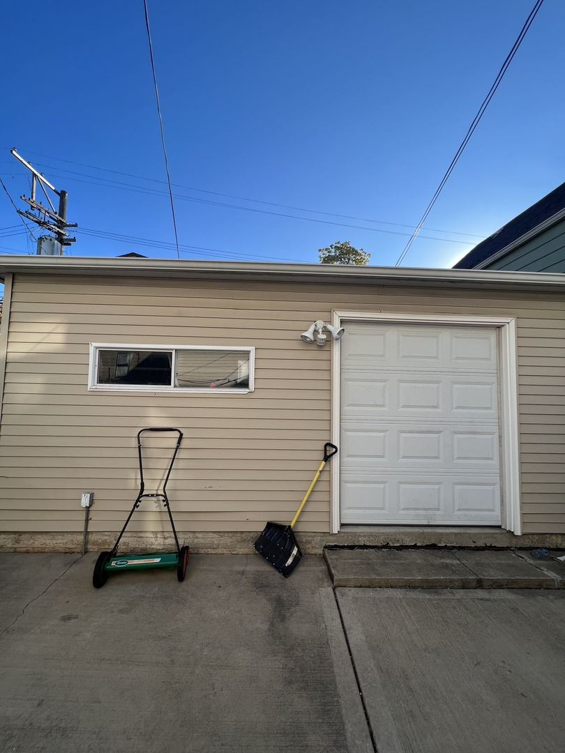 4533 South Richmond Street, Unit 2 Chicago, IL 60632 - Photo 7 of 7 a view of a garage with a table and chairs
