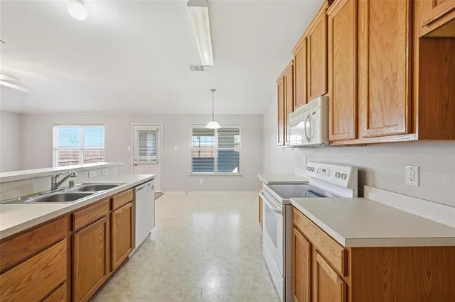 a kitchen with stainless steel appliances granite countertop a sink and cabinets