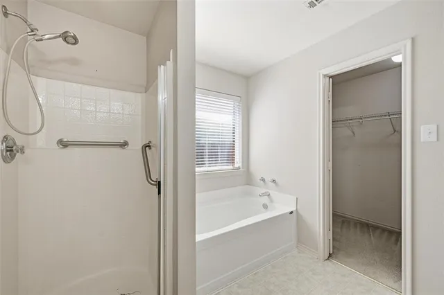 a bathroom with a bathtub and shower