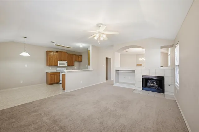 a view of a kitchen with a sink and a fireplace