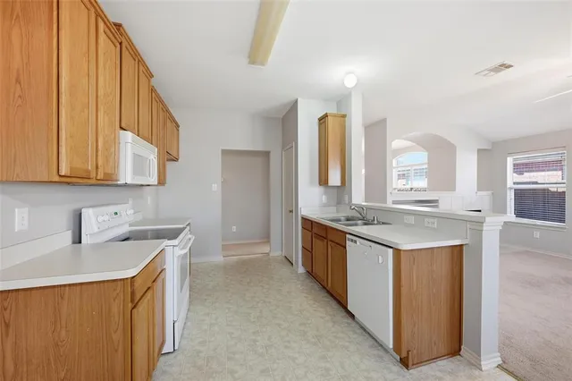 a kitchen with a sink stove and cabinets