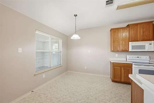 a kitchen with stainless steel appliances granite countertop a sink a stove and a wooden floors