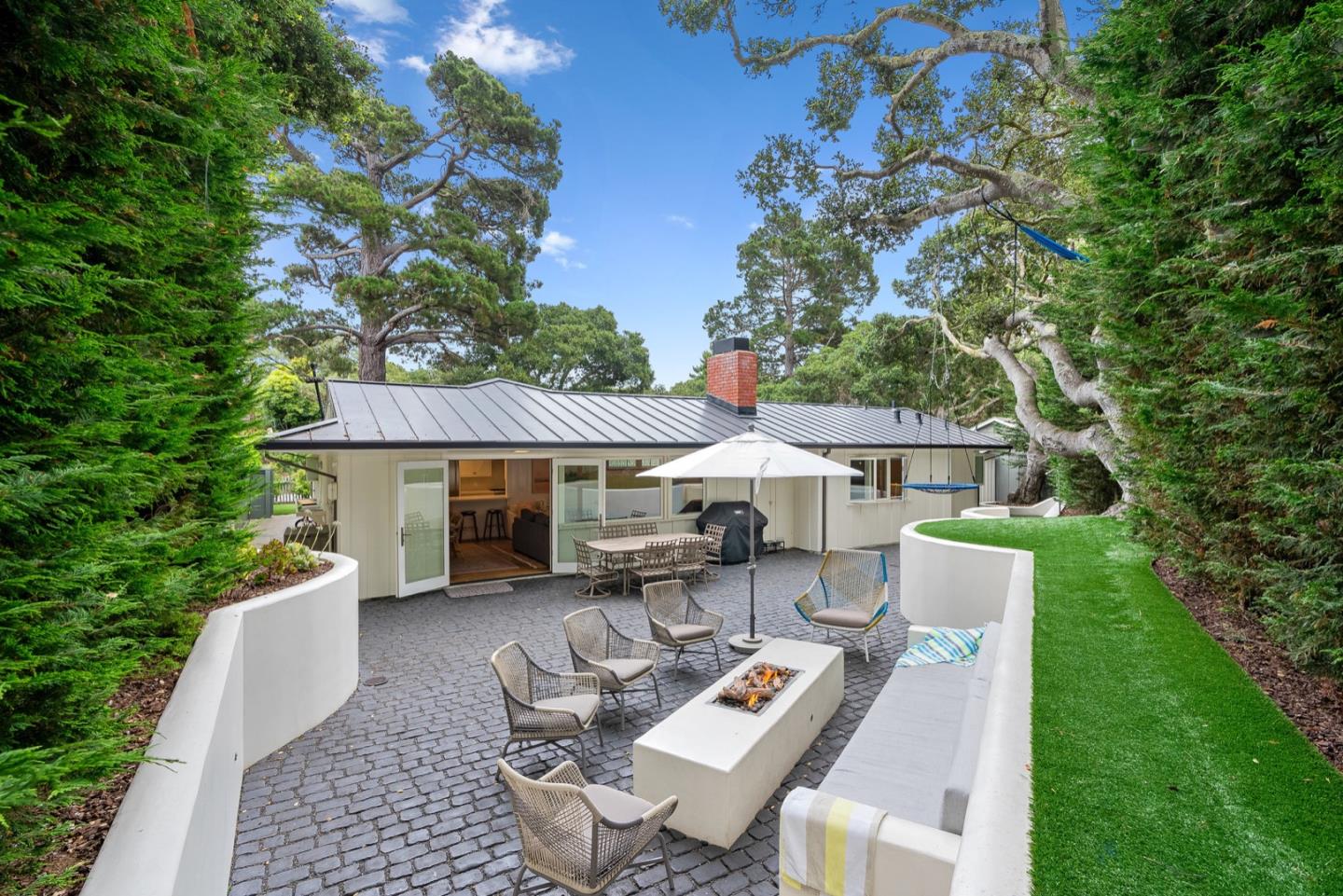 a view of a patio with table and chairs under an umbrella