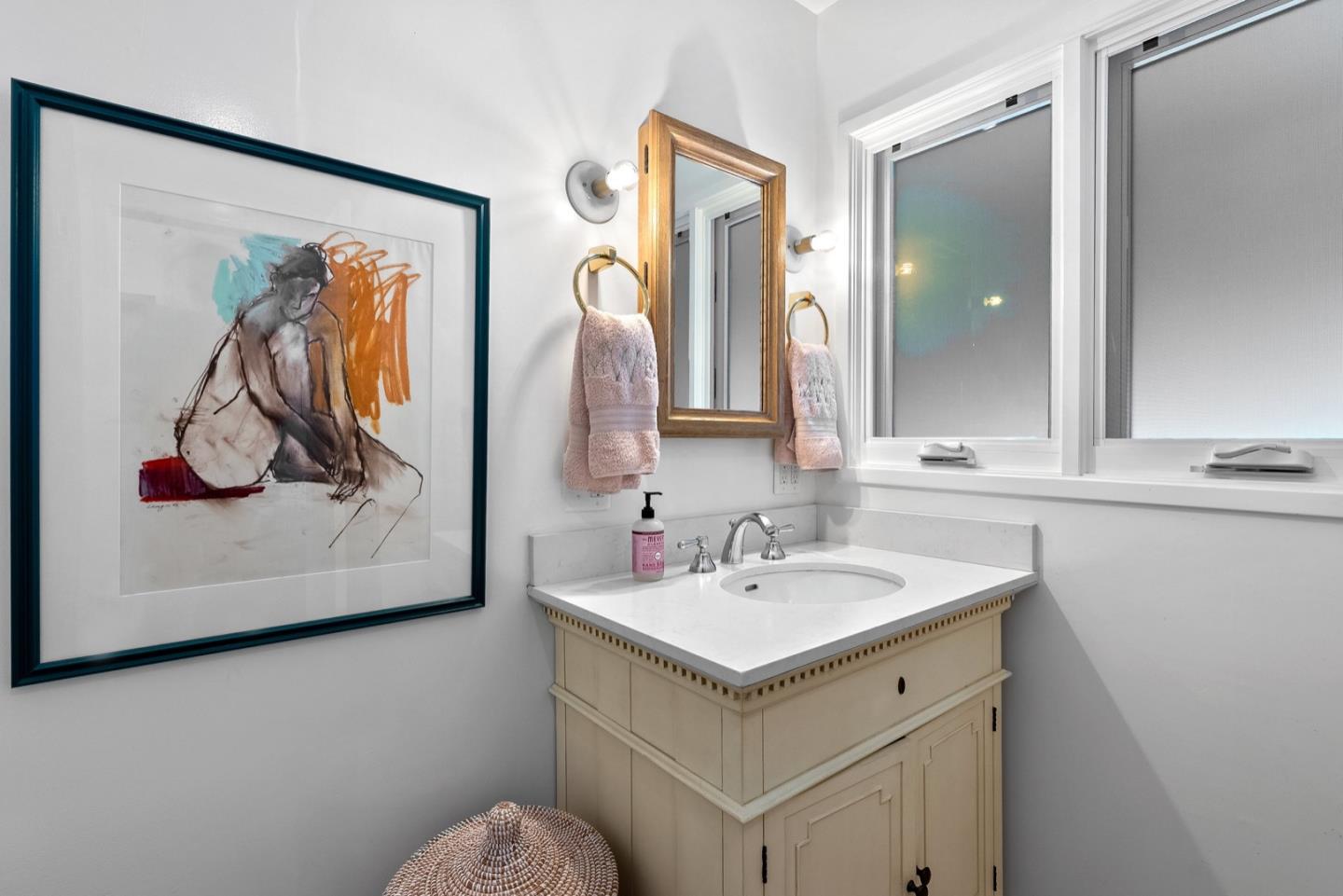 25990 Junipero Street Carmel, CA 93923 - Photo 20 of 26 a bathroom with a sink and a mirror