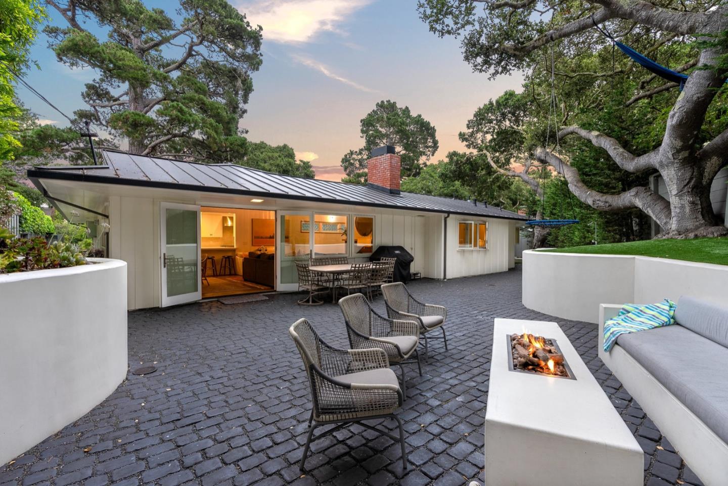 25990 Junipero Street Carmel, CA 93923 - Photo 2 of 26 a view of a patio with couches table and chairs and potted plants