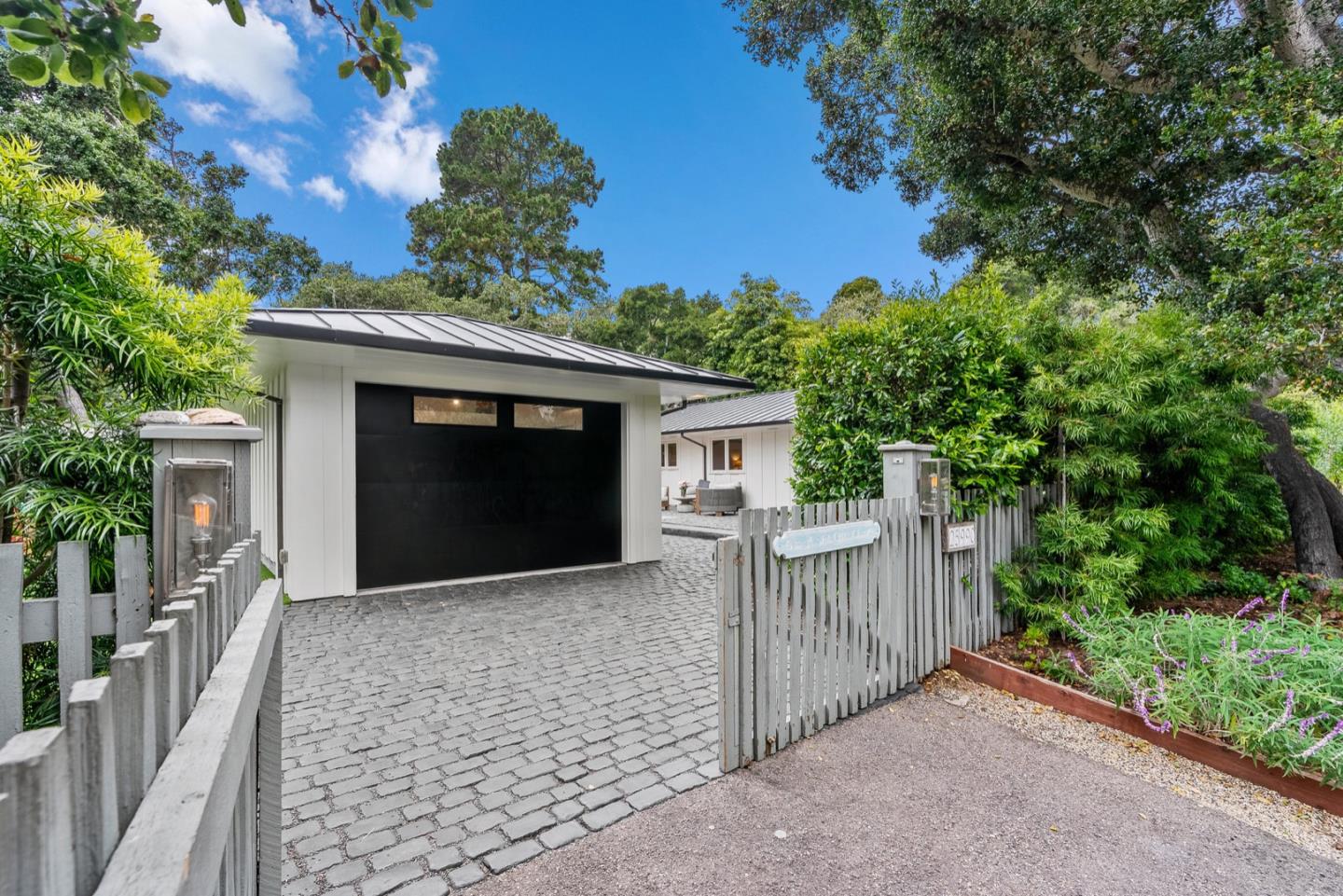 25990 Junipero Street Carmel, CA 93923 - Photo 4 of 26 a front view of a house with a garden