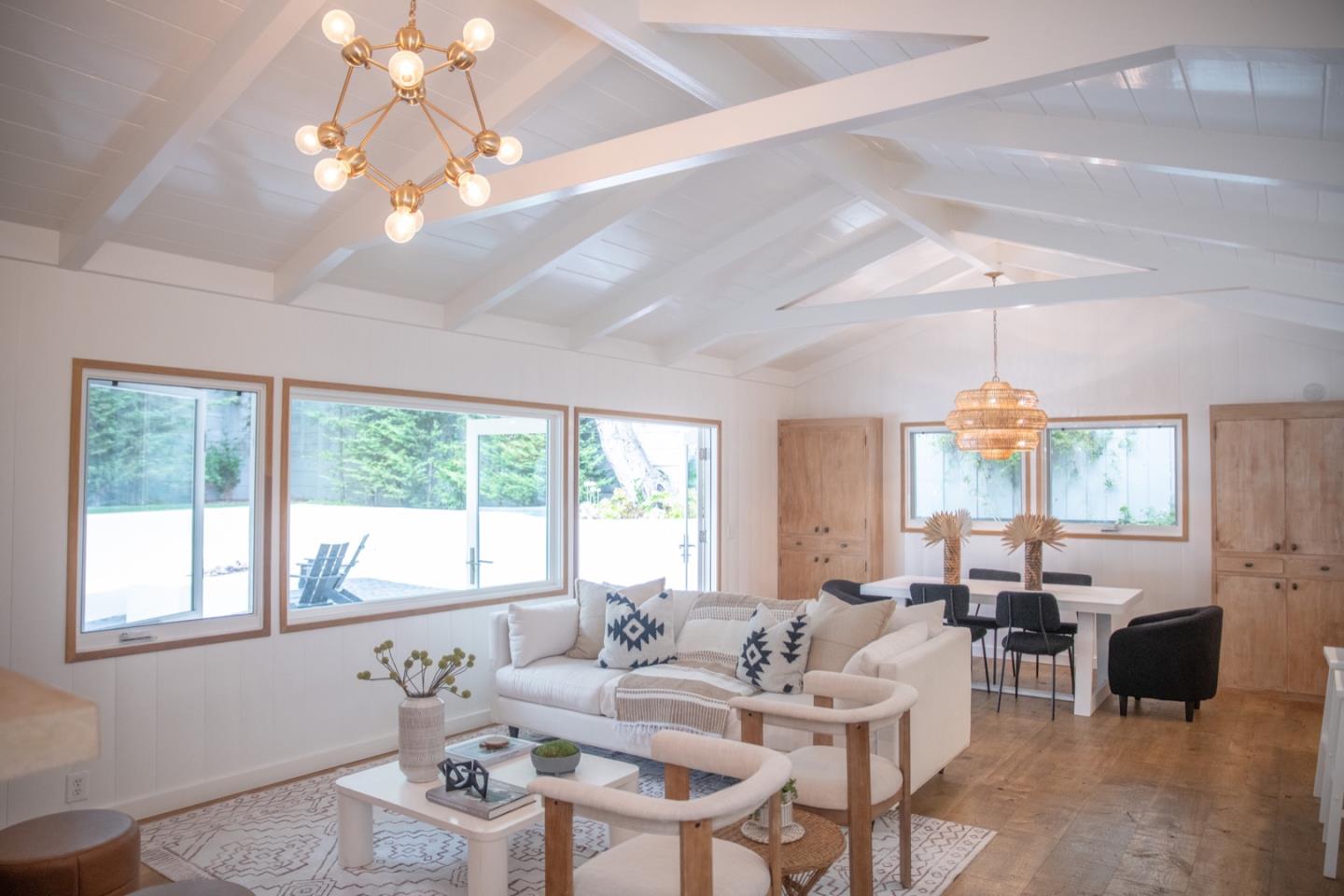 25990 Junipero Street Carmel, CA 93923 - Photo 8 of 26 a living room with furniture chandelier and a large window
