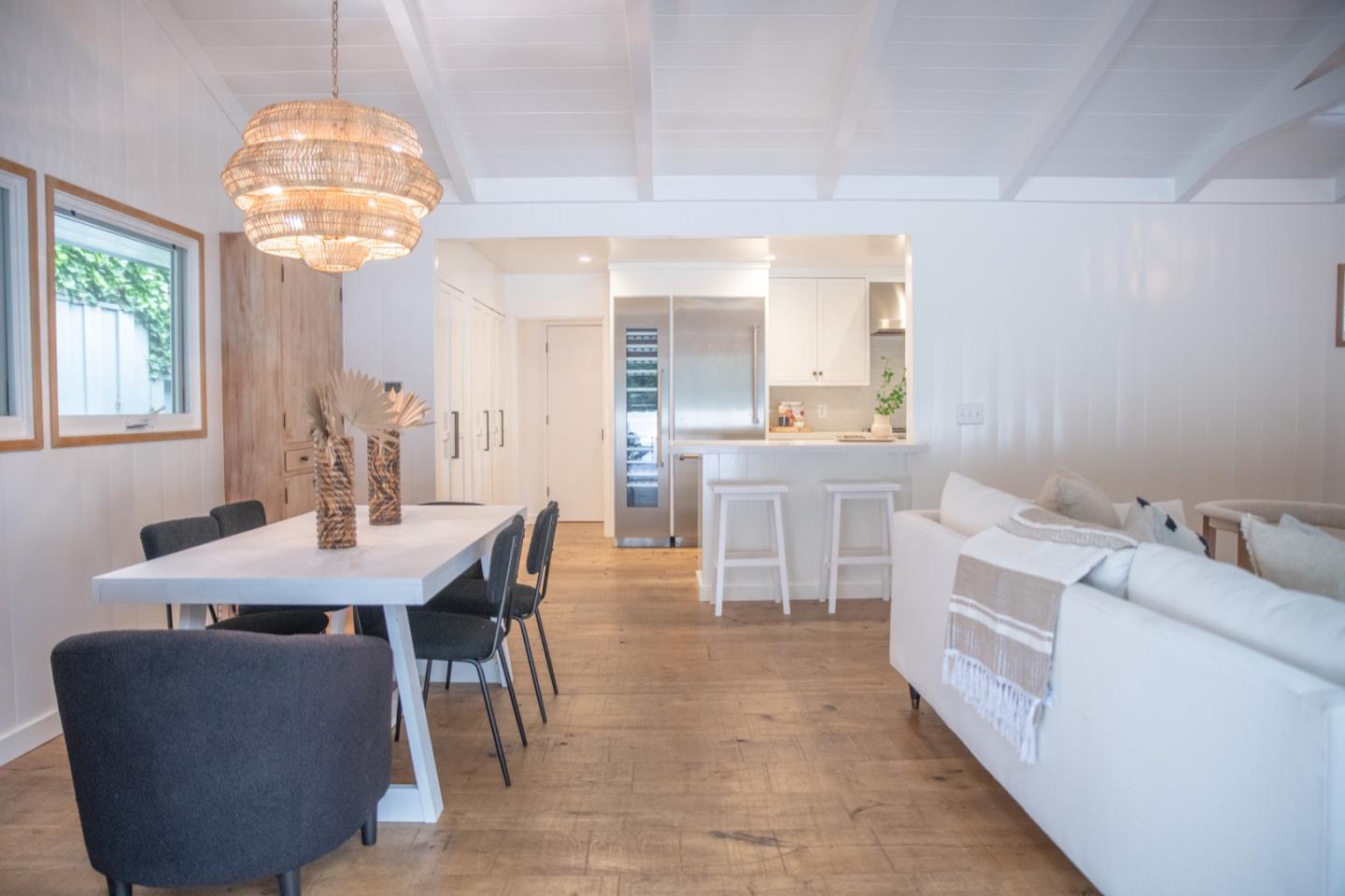 25990 Junipero Street Carmel, CA 93923 - Photo 9 of 26 a large kitchen with kitchen island a large window cabinets a sink and stainless steel appliances