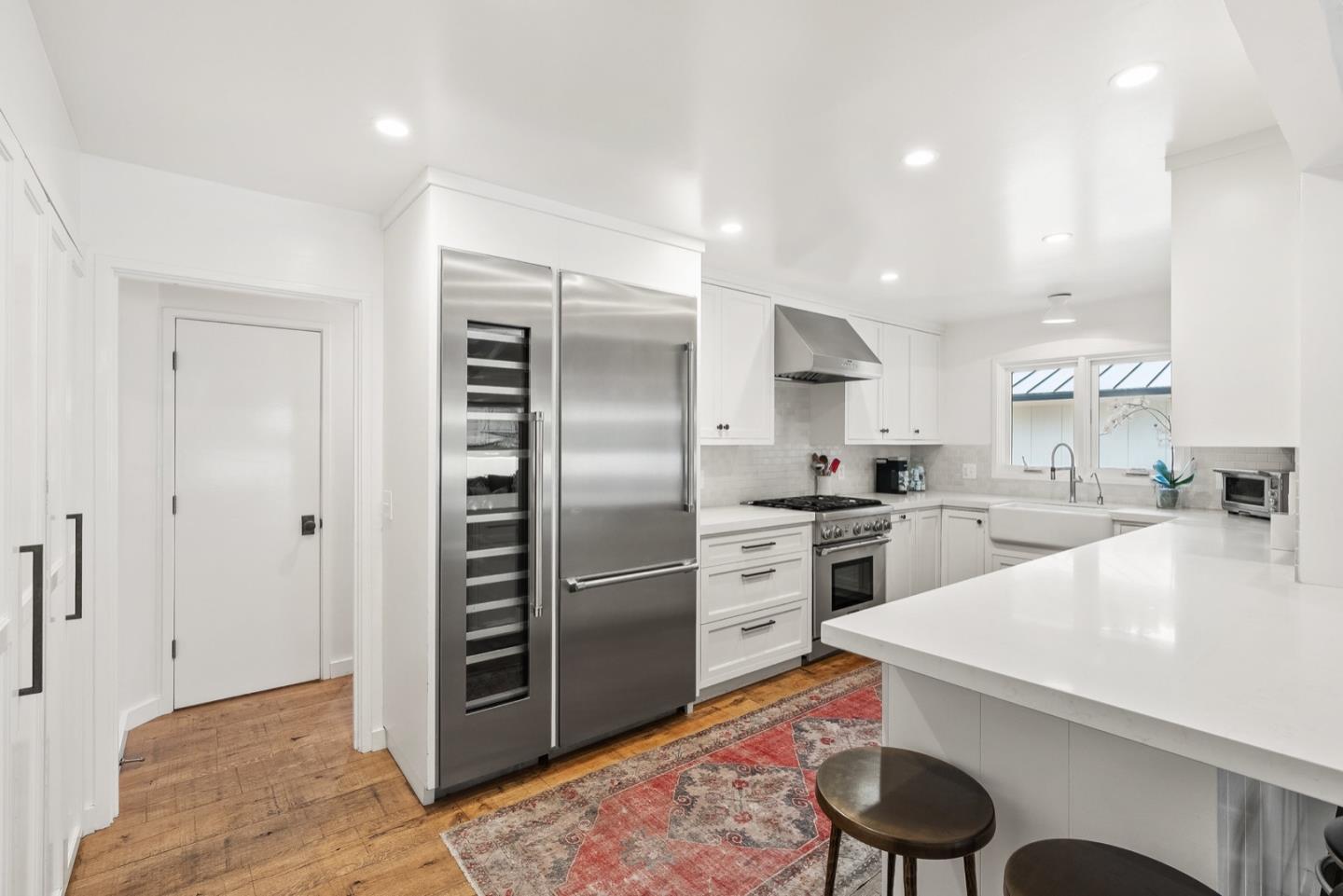 25990 Junipero Street Carmel, CA 93923 - Photo 10 of 26 a kitchen with stainless steel appliances kitchen island granite countertop a sink refrigerator and cabinets