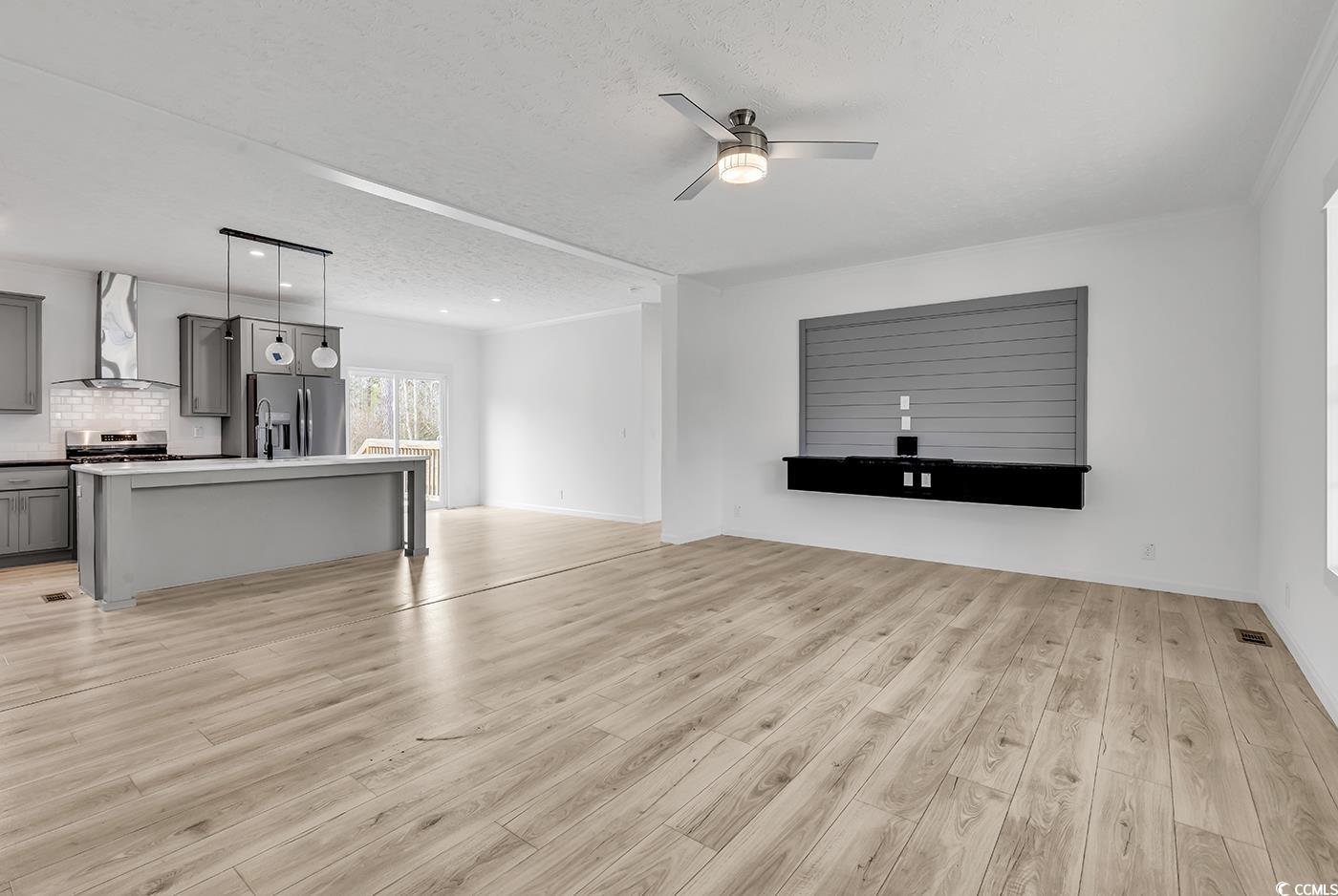 7740 Kerl Road Conway, SC 29526 - Photo 8 of 39 Living area featuring a textured ceiling, visible vents, light wood-style flooring, and a ceiling fan