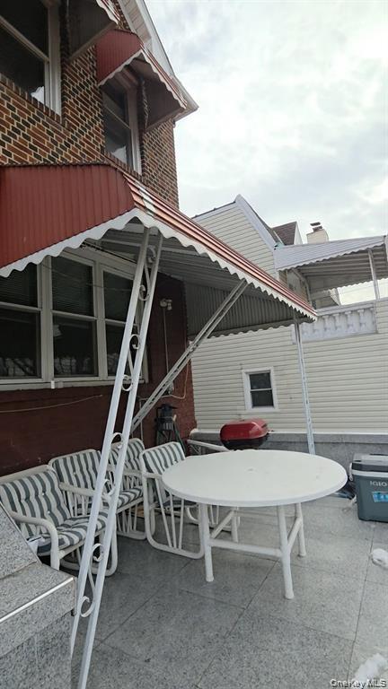 25-55 97th Street Queens, NY 11369 - Photo 15 of 15 a roof deck with table and chairs