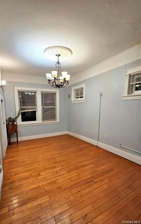25-55 97th Street Queens, NY 11369 - Photo 8 of 15 a view of an empty room with window and wooden floor