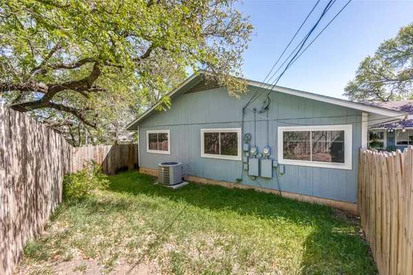 a house with green field in front of it