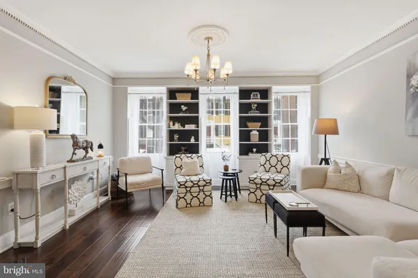 a kitchen with a sink dishwasher a dining table and chairs with wooden floor